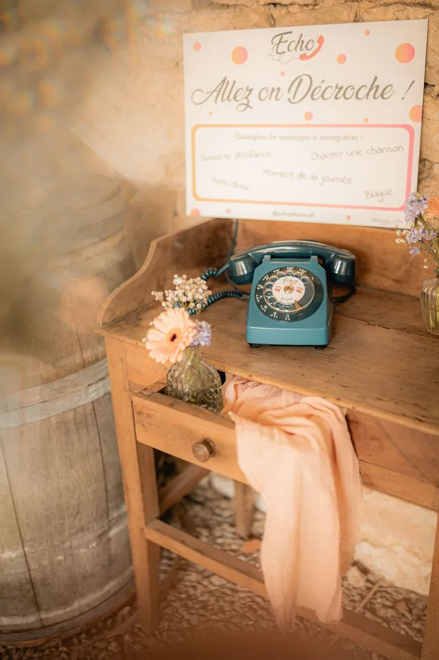 Audio guest book corner with a blue phone, flowers and a barrel